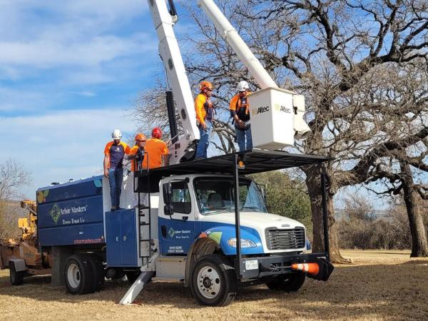 AM-Local-page-section-men-bucket-truck-near-trees