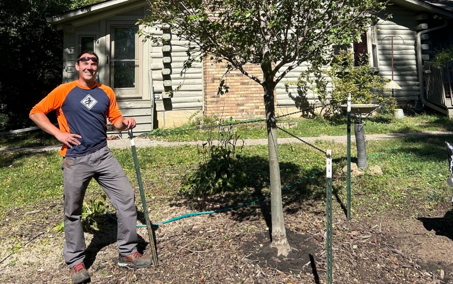 Arbor Masters certified arborist consulting with Tulsa homeowner about proper tree placement and species selection for new development.