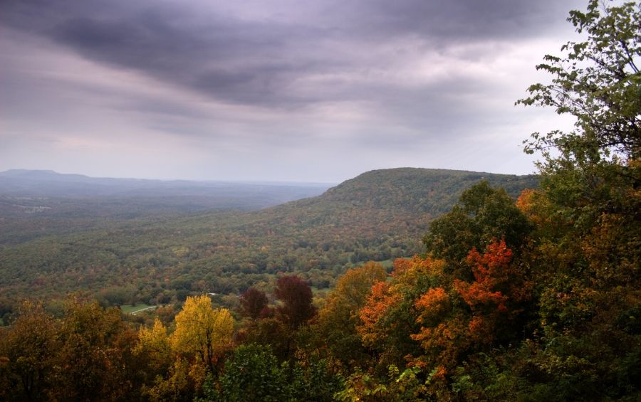 Ozark Mountains during fall season with trees turning yellow, orange and red.