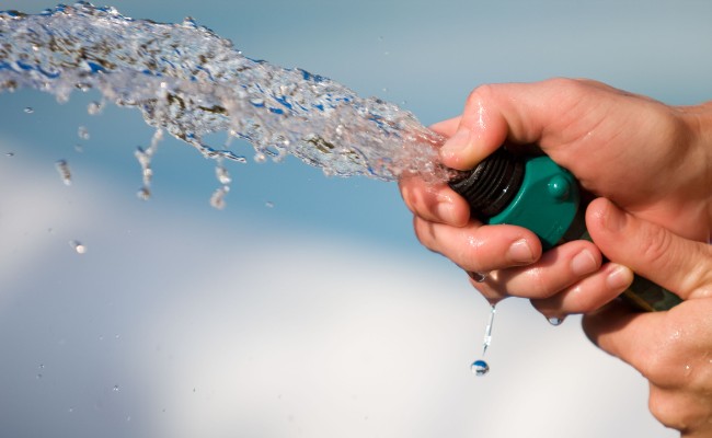 Website-Davenport-seasonal-tips-summer-watering-hose-hands