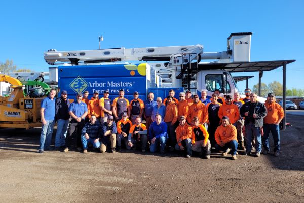 Arbor Master team with a bucket truck background on a fine sunny day in Mustang, OK.