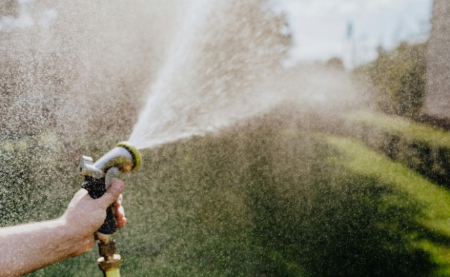 Website-Wichita-seasonal-tips-summer-wateringhose-garden-hand Website-Wichita-seasonal-tips-summer-wateringhose-garden-hand