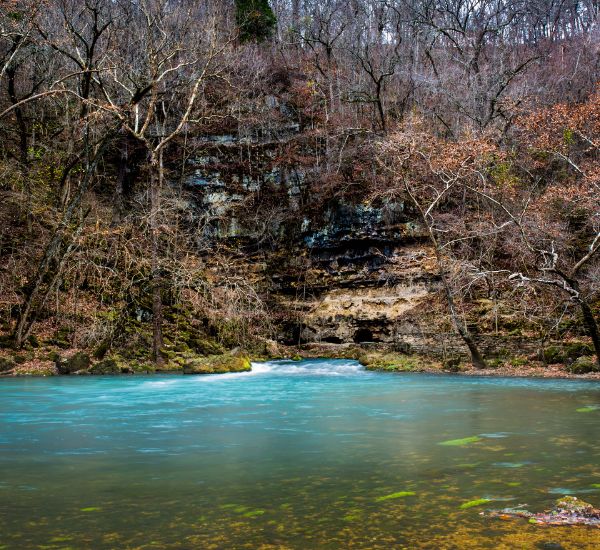 Blue Springs Lake with teal waters on a fall day.